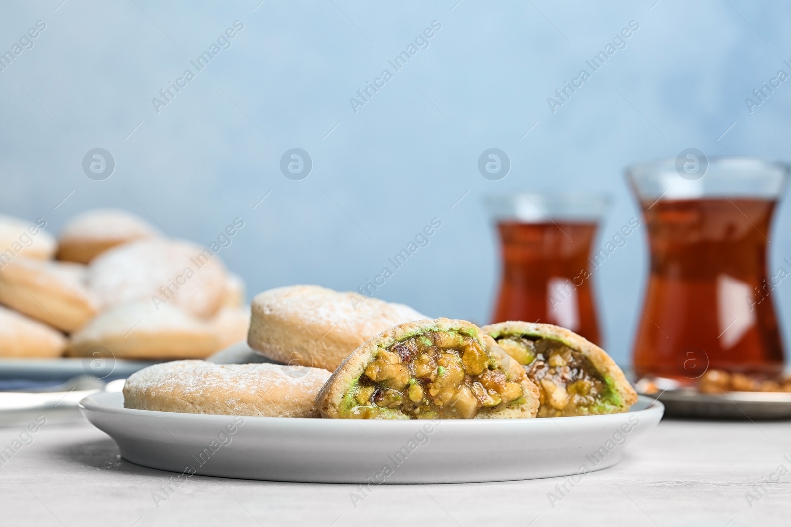 Photo of Plate of traditional cookies for Islamic holidays on table. Eid Mubarak