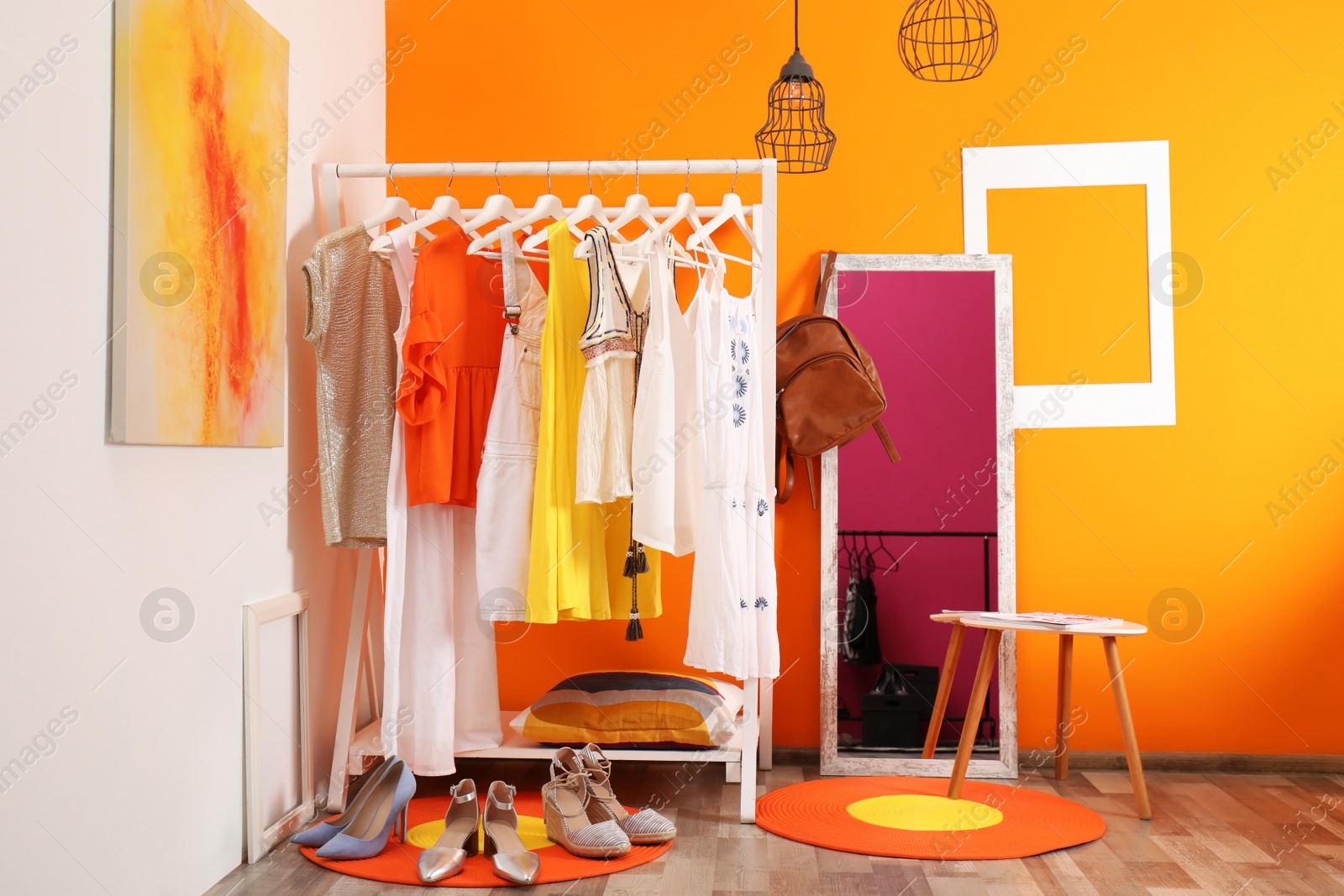 Photo of Stylish dressing room interior with clothes rack and mirror