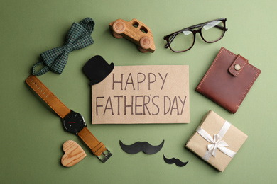 Photo of Flat lay composition with greeting card on green background. Happy Father's Day