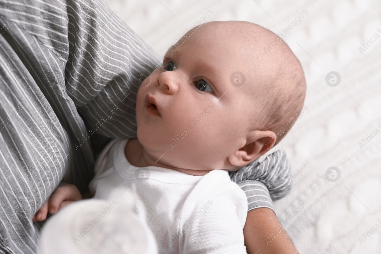 Photo of Mother with her little baby on bed, closeup