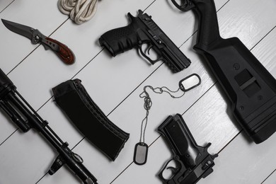 Photo of Flat lay composition with different guns on white wooden background