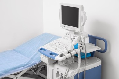 Photo of Ultrasound machine and examination table in hospital