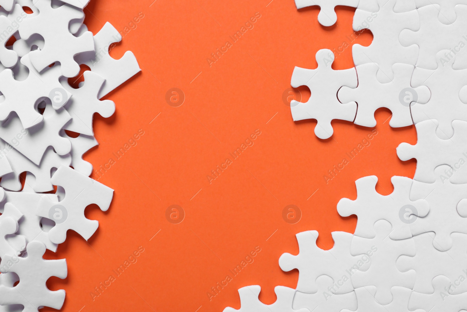 Photo of Blank white puzzle pieces on orange background, flat lay