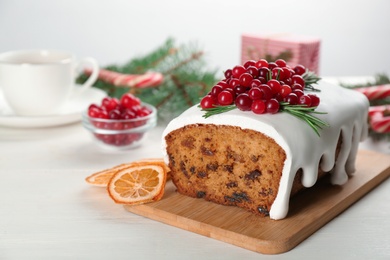 Photo of Traditional Christmas cake on white wooden table. Classic recipe