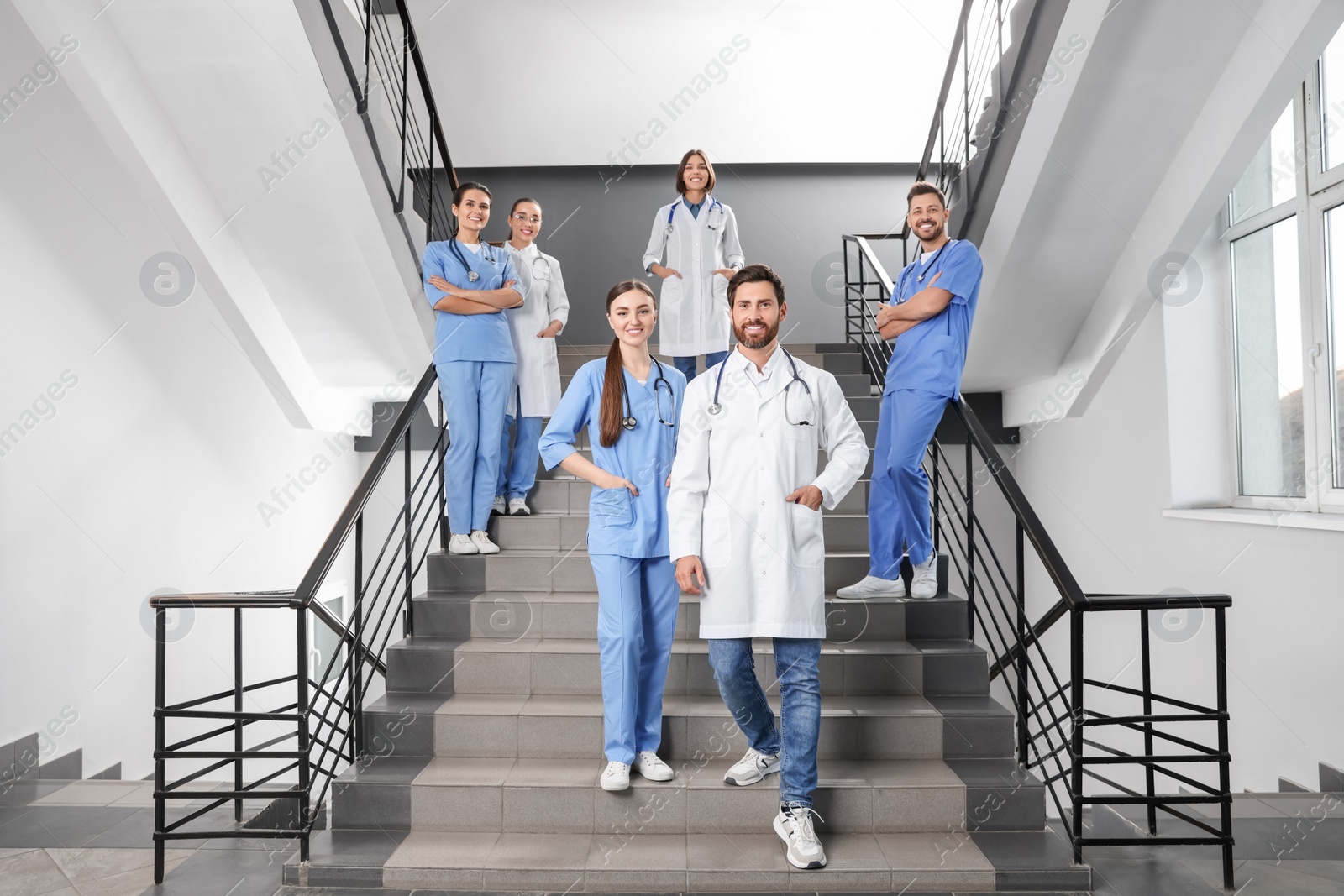 Photo of Medical students wearing uniforms on staircase in college