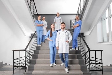 Photo of Medical students wearing uniforms on staircase in college