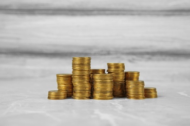 Many stacks of coins on table color background