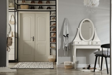 Photo of Dressing room interior with storage rack for shoes and accessories