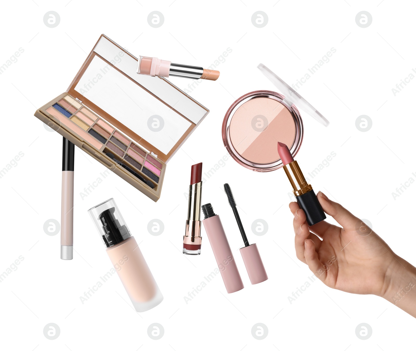 Image of Woman holding nude lipstick on white background, closeup. Other decorative cosmetics in air near her hand. Makeup products