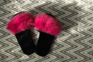 Photo of Fluffy women's slippers on carpet, flat lay. Space for text