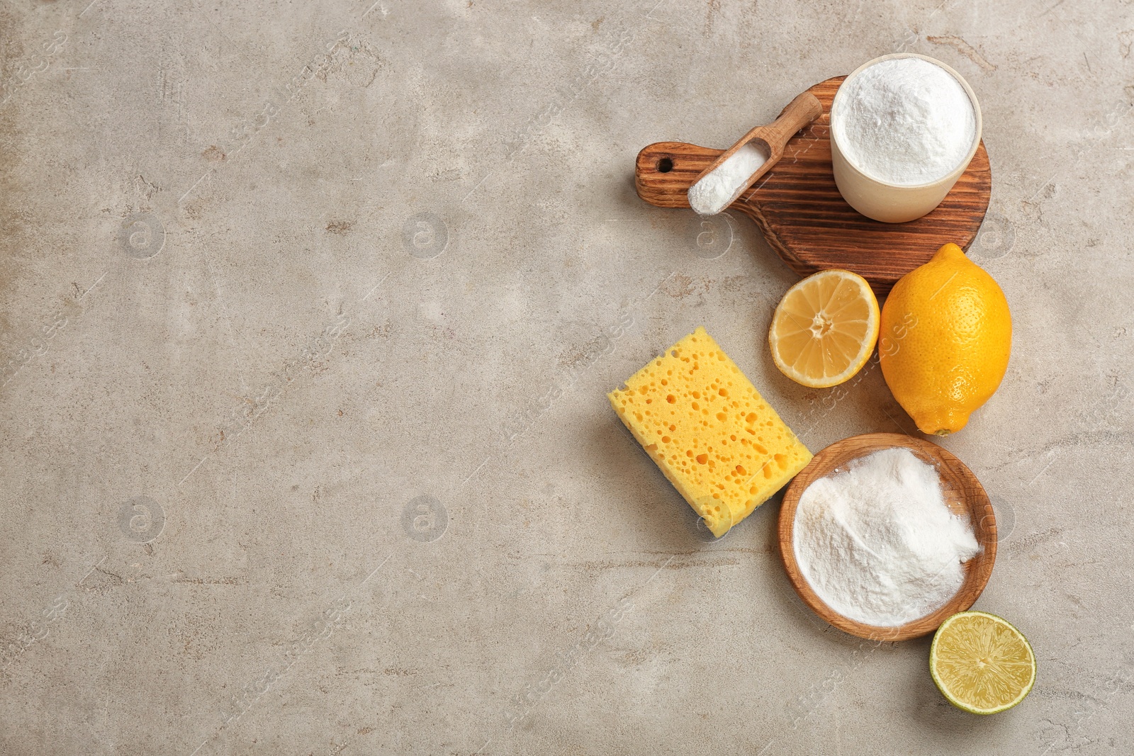 Photo of Flat lay composition with bowls of baking soda and space for text on gray table