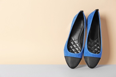 Photo of Pair of female shoes on color background