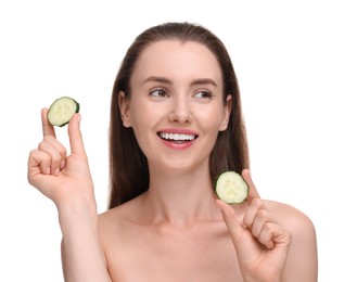 Beautiful woman with pieces of cucumber on white background