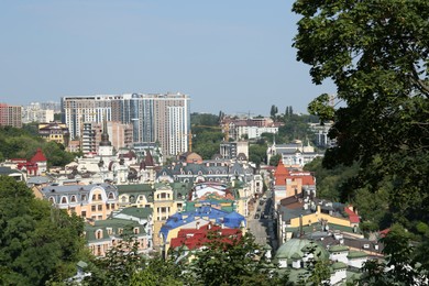 Photo of View of beautiful city with buildings and trees on sunny day