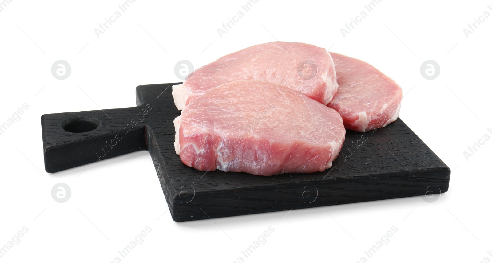 Photo of Black wooden board with pieces of raw pork meat isolated on white