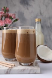 Photo of Delicious coffee with coconut syrup on white table