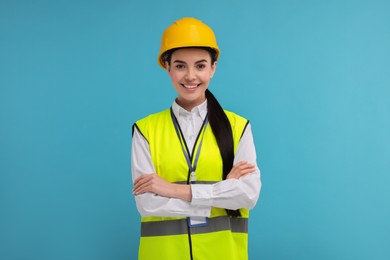 Engineer with hard hat and badge on light blue background