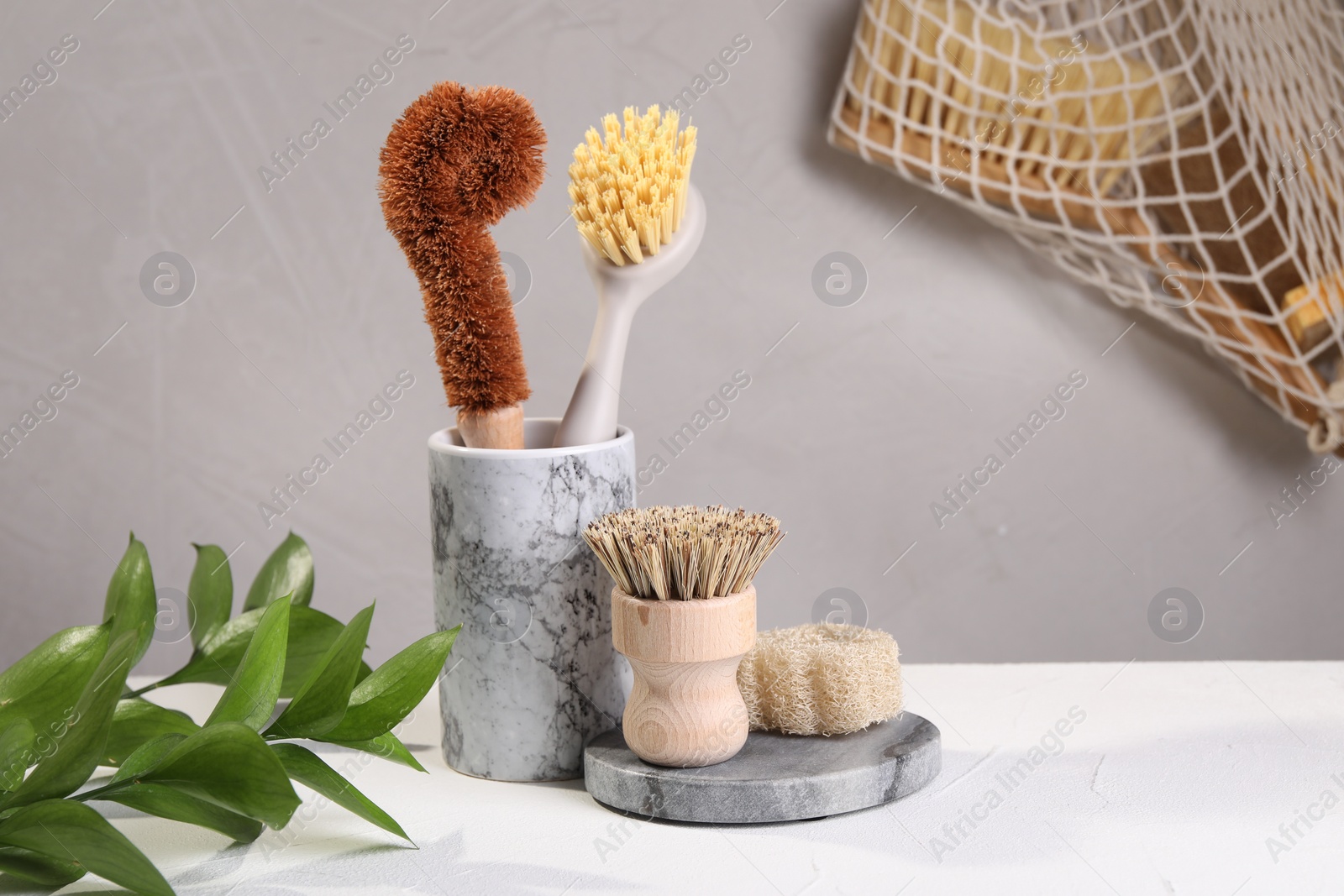 Photo of Set of cleaning brushes on white table