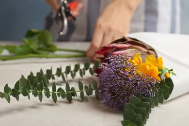 Beautiful bouquet and blurred florist on background