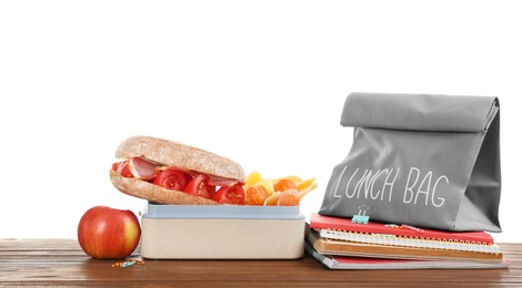 Photo of Lunch box with appetizing food and bag on table against white background