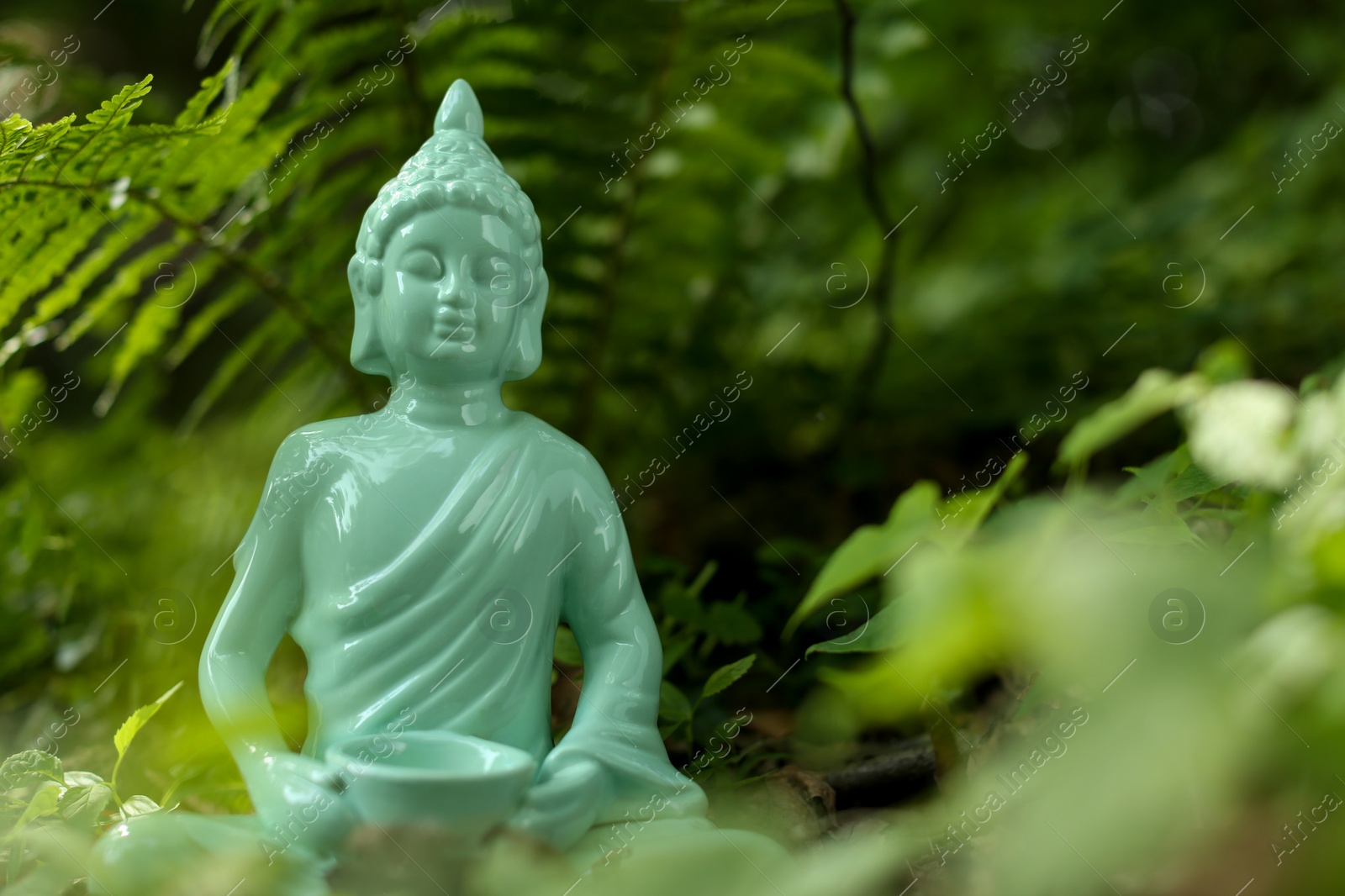 Photo of Decorative Buddha statue outdoors. Space for text