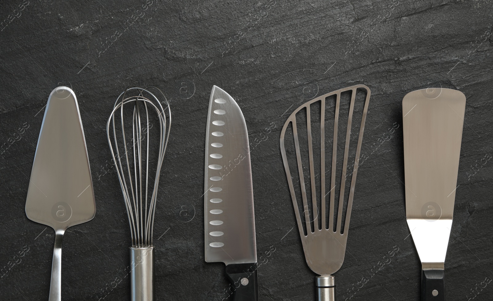 Photo of Cooking utensils on black table, flat lay