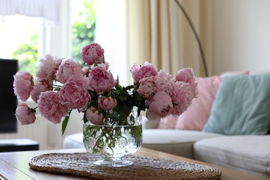 Photo of Beautiful pink peonies in vase on table at home, space for text. Interior design