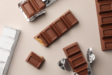 Tasty chocolate bars on light background, flat lay