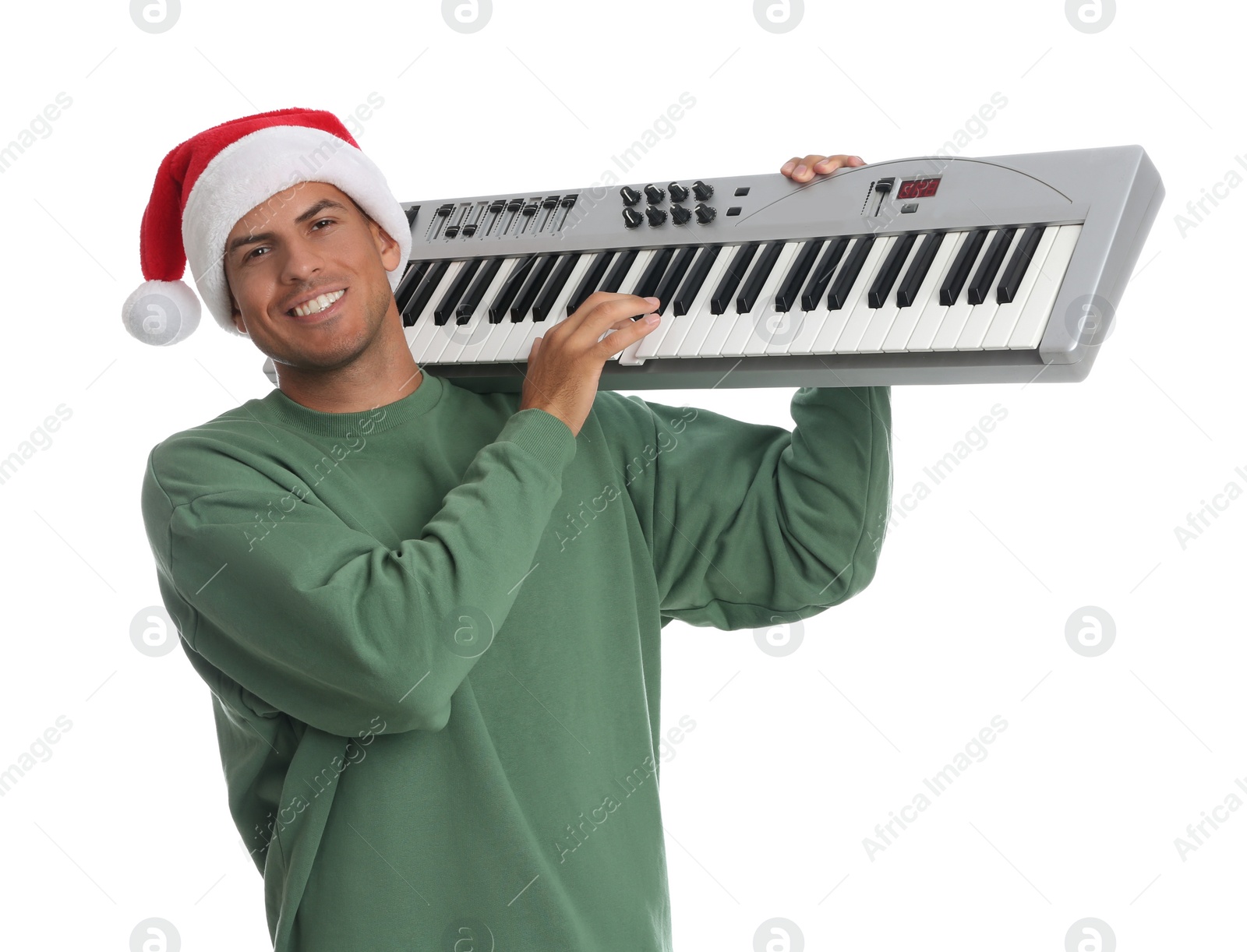 Photo of Man in Santa hat playing synthesizer on white background. Christmas music