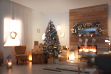 Photo of Blurred view of living room interior with decorated Christmas tree