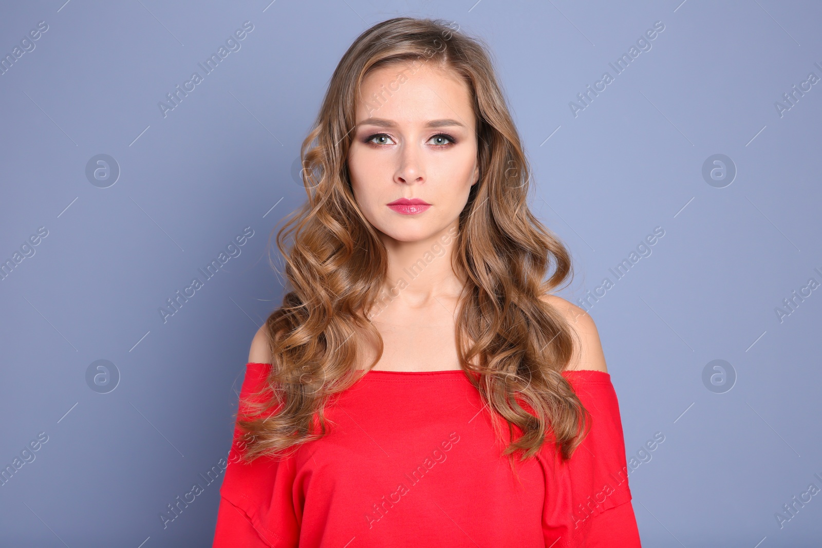 Photo of Portrait of young woman with long beautiful hair on grey background