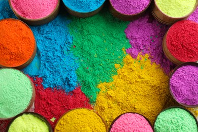 Photo of Colorful powder dyes as background, top view. Holi festival