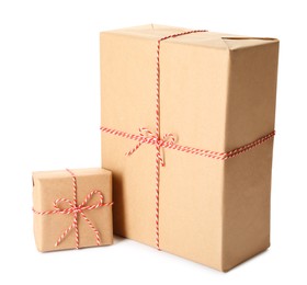 Photo of Gift boxes wrapped in kraft paper with bows on white background