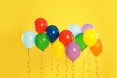 Photo of Bright balloons on color background. Celebration time