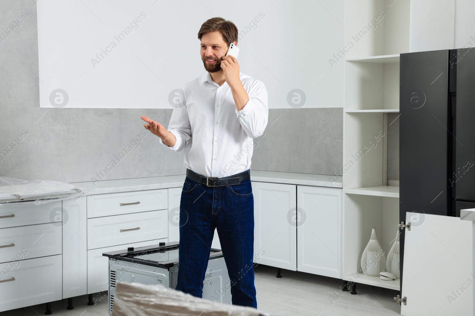 Photo of Man in casual clothes talking on phone indoors