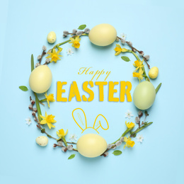 Flat lay composition with eggs and text Happy Easter on light blue background, top view