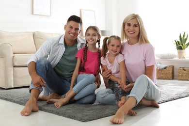 Portrait of happy family on floor at home