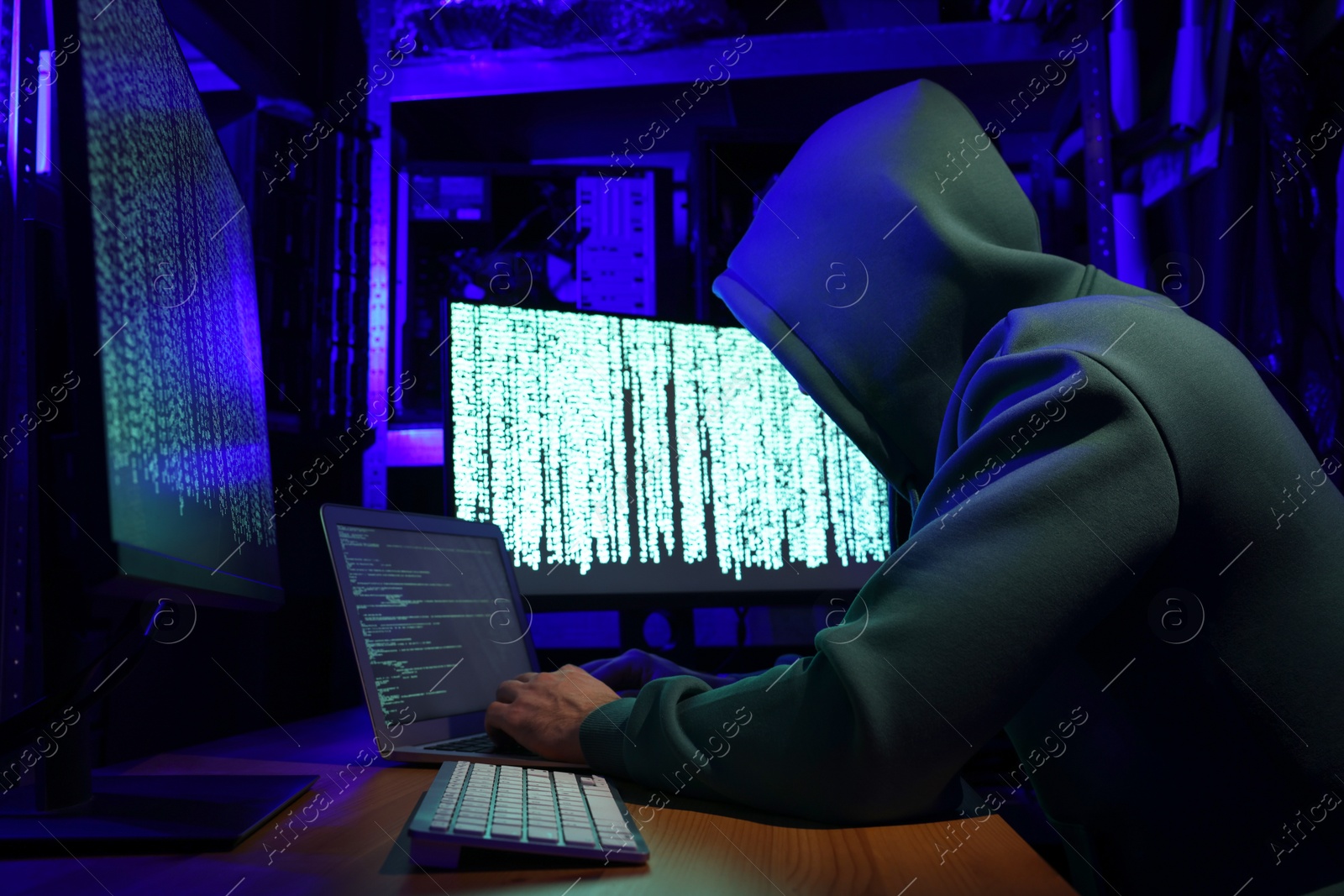 Photo of Hacker working with computers in dark room. Cyber attack