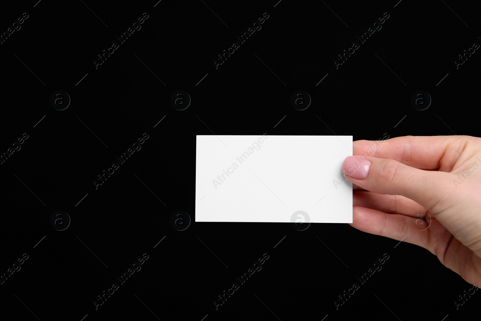 Photo of Woman holding blank business card on black background, closeup. Space for text