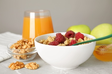 Healthy breakfast with granola and berries on light grey marble table, closeup