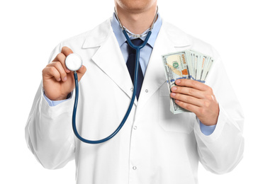 Doctor with bribe and stethoscope on white background, closeup. Corruption in medicine