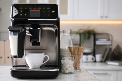 Photo of Modern coffee machine with cup in office kitchen, space for text