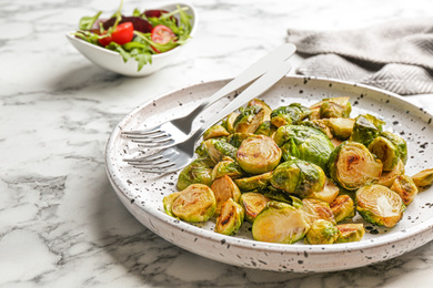 Delicious roasted brussels sprouts on white marble table