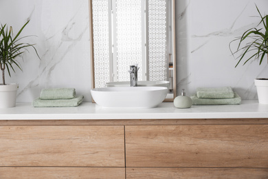 Photo of Large mirror and vessel sink in bathroom