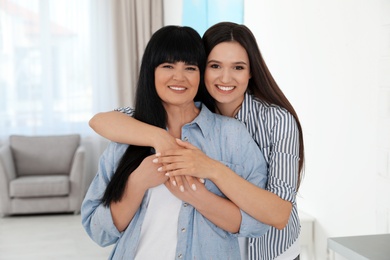 Photo of Portrait of young woman and her mature mother indoors