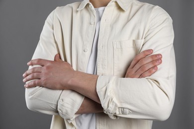 Photo of Man with space for tattoo on his hands against grey background, closeup