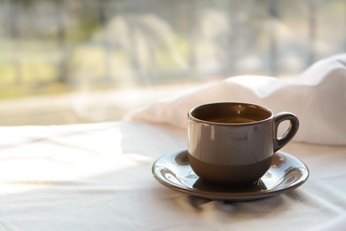 Aromatic morning coffee on bed indoors, space for text