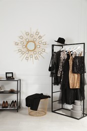 Stylish dressing room interior with trendy clothes, shoes and accessories