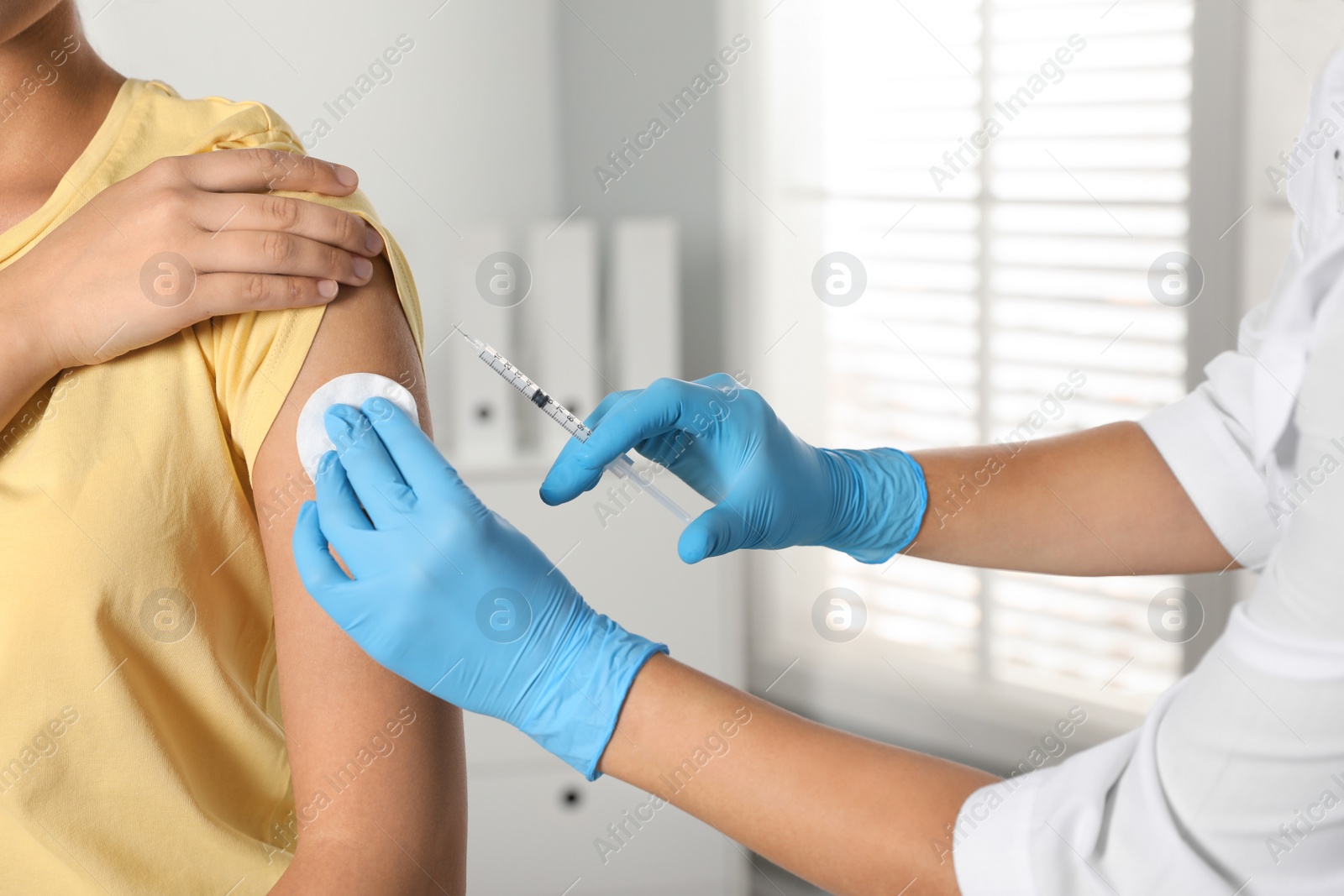 Photo of Doctor giving injection to patient in hospital, closeup. Vaccination day