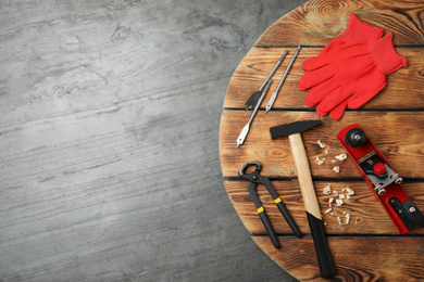 Photo of Different carpenter's tools on grey stone background, flat lay. Space for text